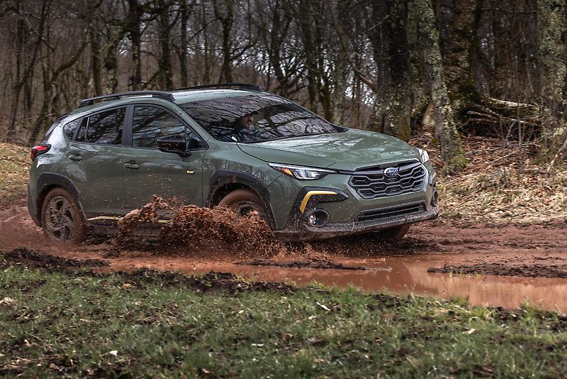 A 2024 Subaru Crosstrek driving through mud