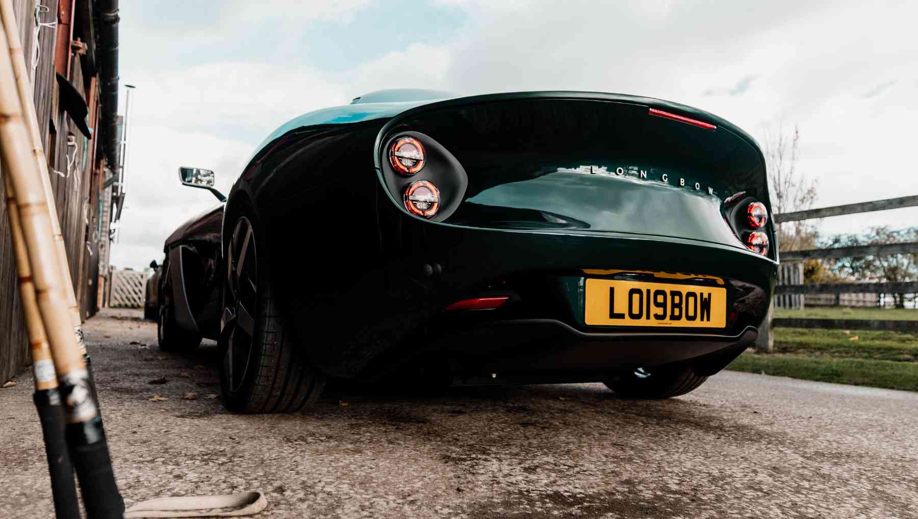 A rear view of a green Longbow EV Speedster