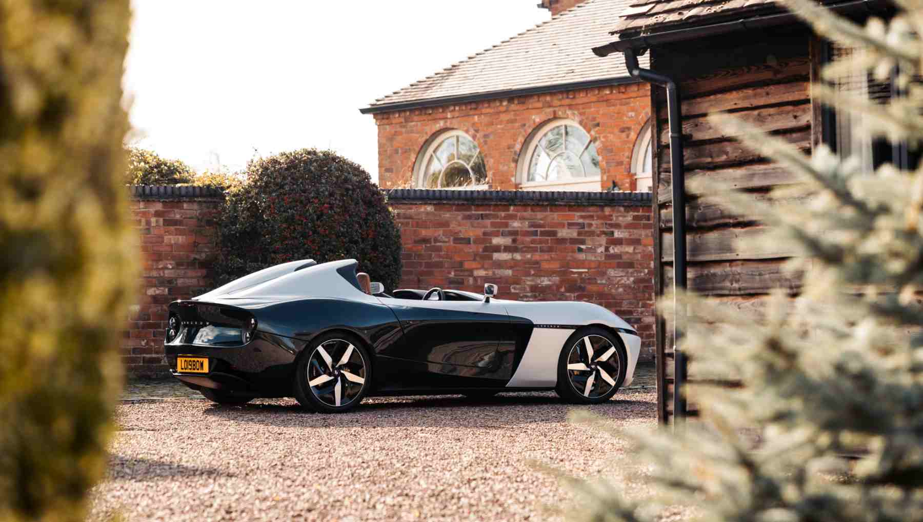 A side view of a silver and black Longbow EV Speedster
