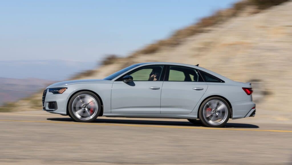 Side view of a grey Audi S6 sedan on sand