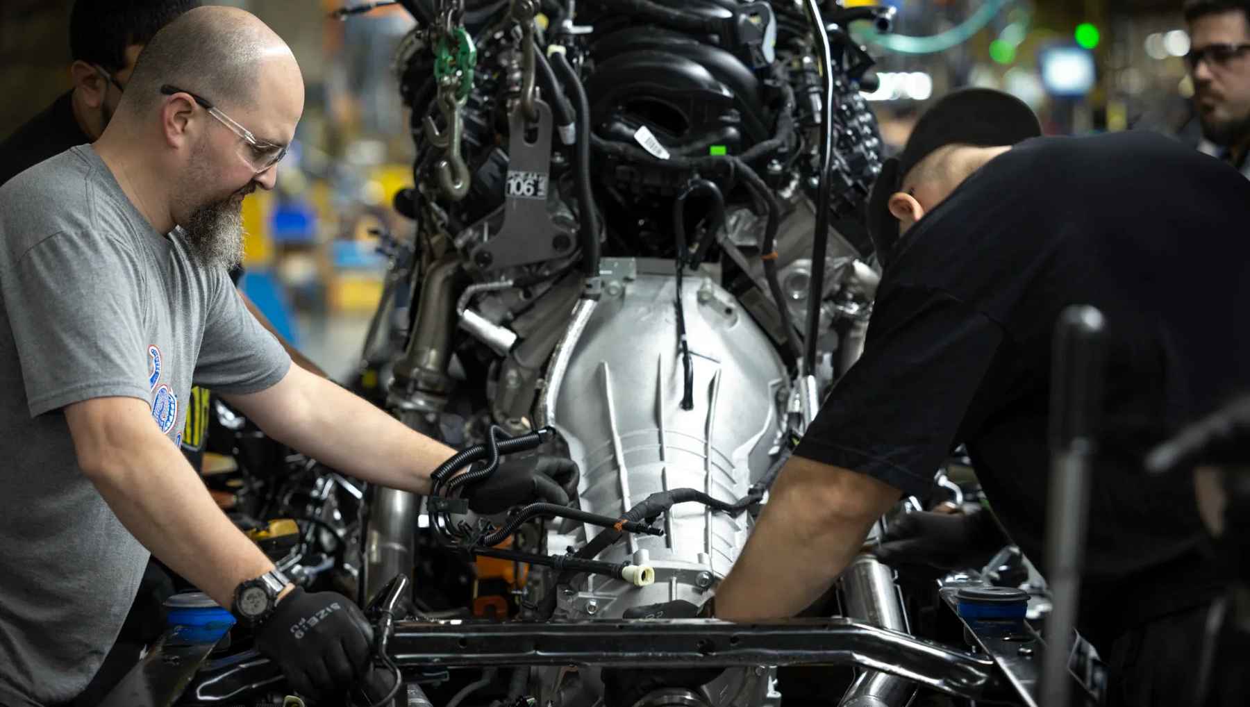 Two Ford Workers with a transmission