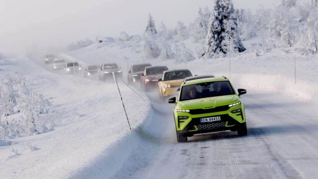 A line of EVs driving down an iced over road