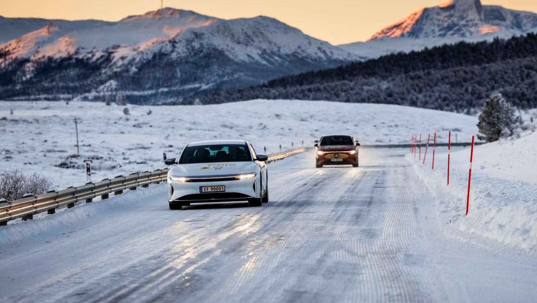 Two EVs driving down an ice road