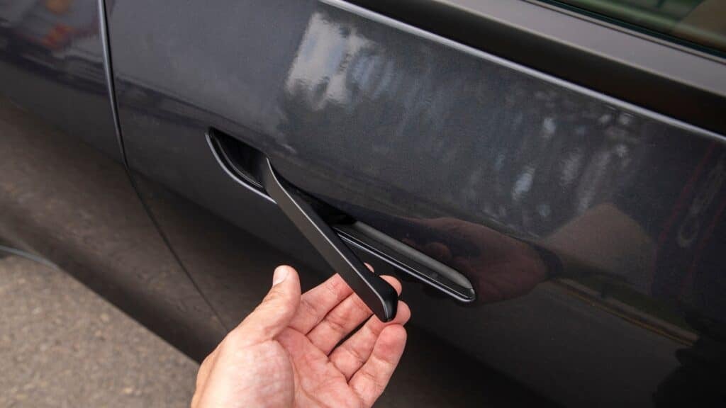 man opening tesla hidden door handle