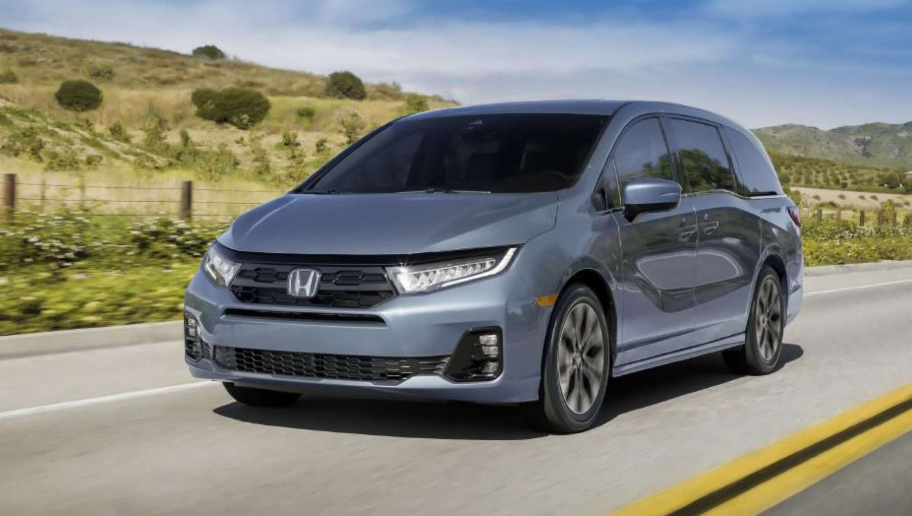 A 2026 Honda Odyssey driving down a rural highway