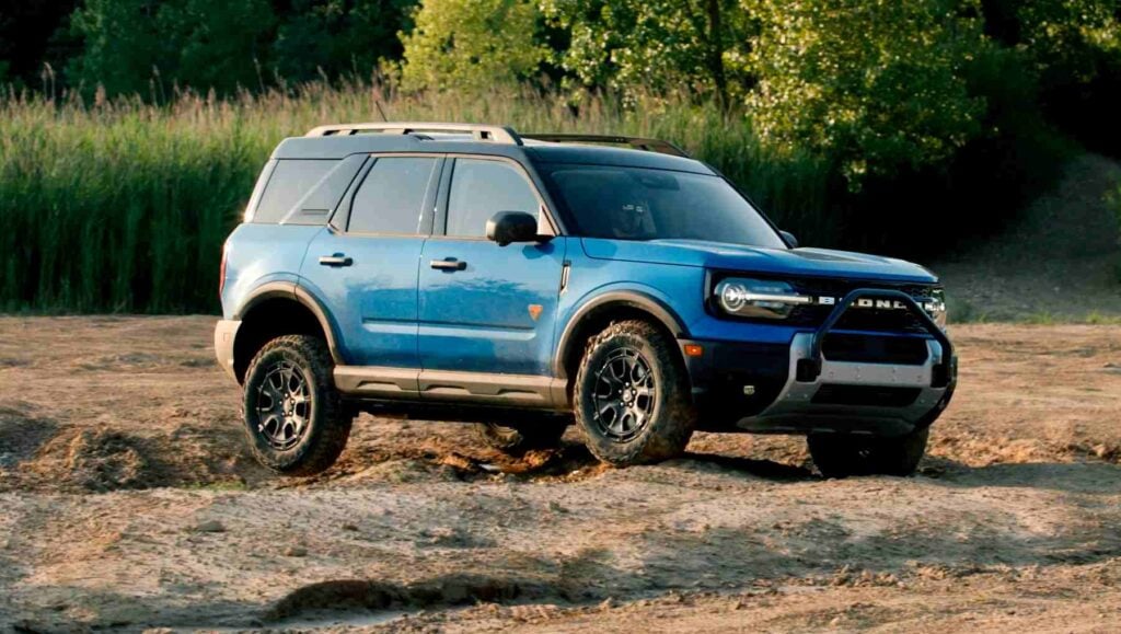 A 2025 Ford Bronco Sport driving through a field