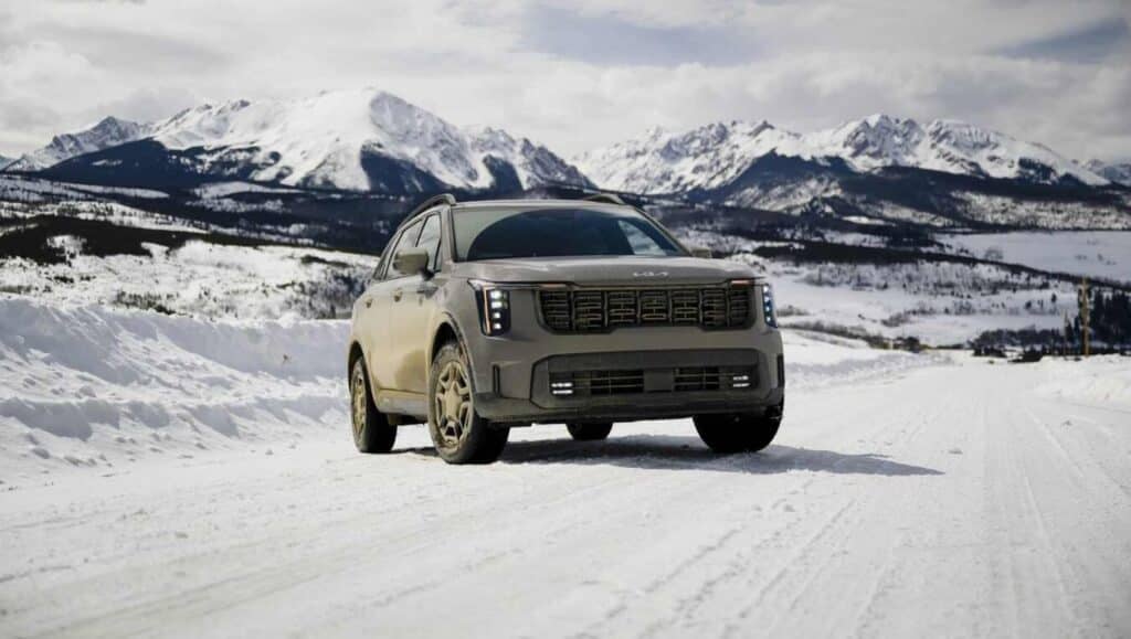 A front view of a 2026 Kia Sorento on ice in front of mountains