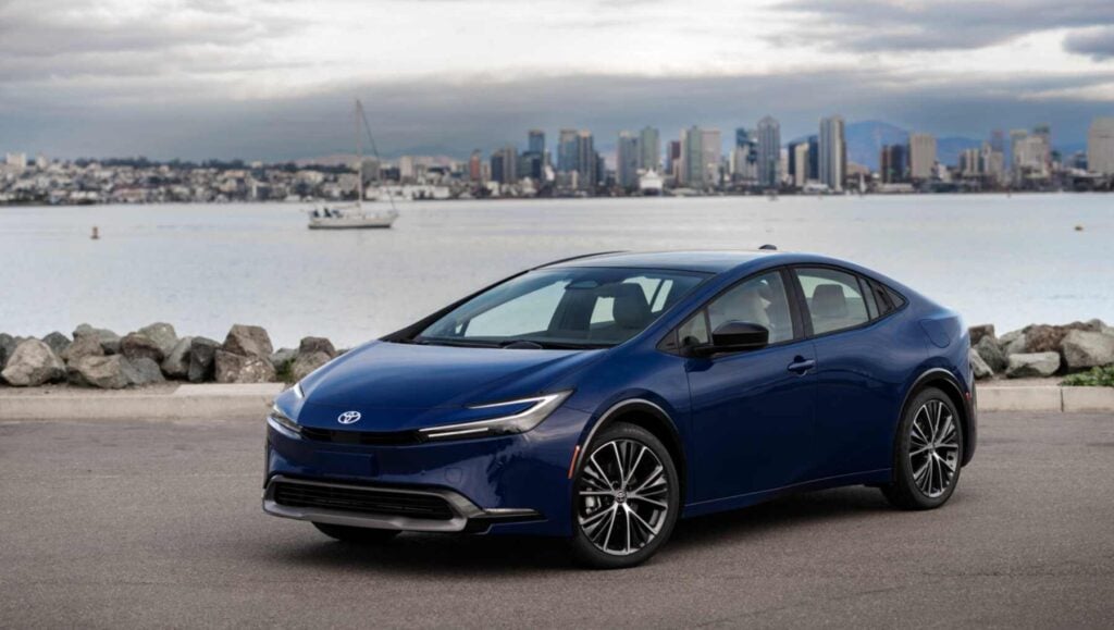 A Blue Toyota Prius by the sea