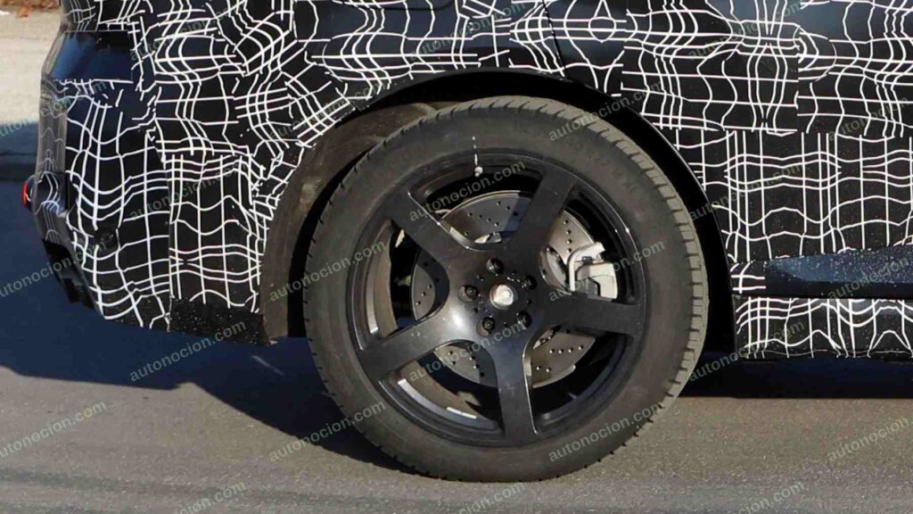 A shot of a camouflaged pre-production 2027 BMW X5