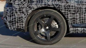 A shot of a camouflaged pre-production 2027 BMW X5