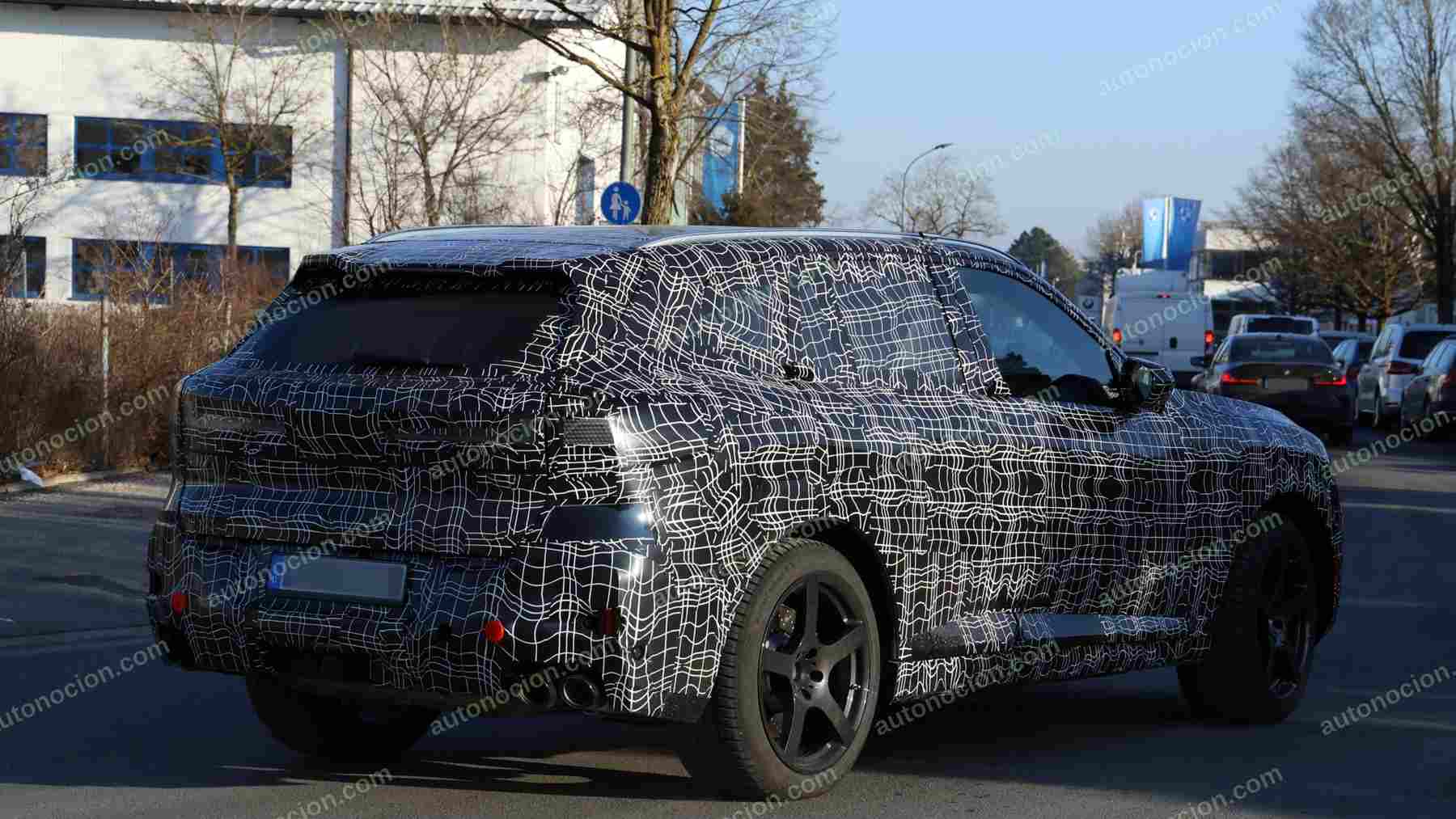 A shot of a camouflaged pre-production 2027 BMW X5