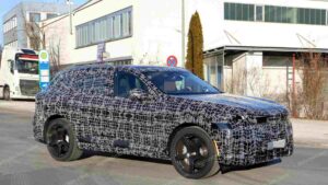 A shot of a camouflaged pre-production 2027 BMW X5