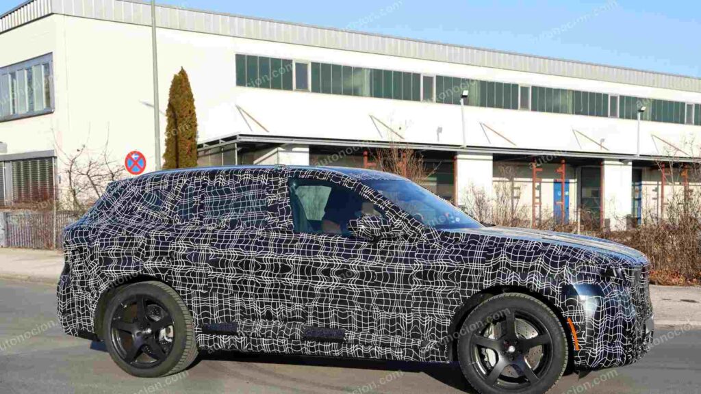 A shot of a camouflaged pre-production 2027 BMW X5