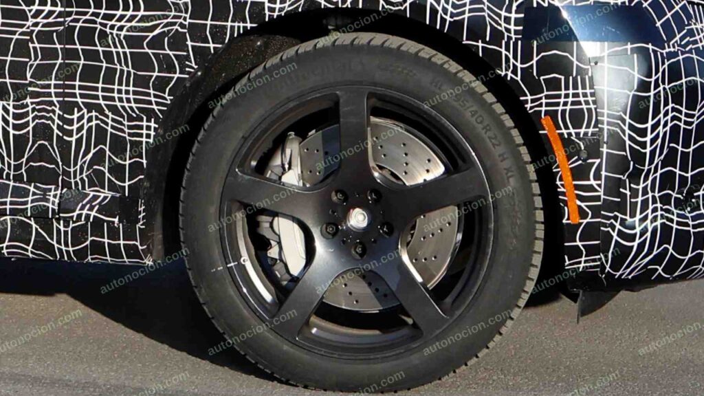 A shot of a camouflaged pre-production 2027 BMW X5