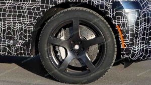 A shot of a camouflaged pre-production 2027 BMW X5