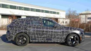 A shot of a camouflaged pre-production 2027 BMW X5