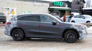 A camouflaged Mercedes-AMG GLC EQ prototype testing in a winter environment