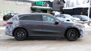 A camouflaged Mercedes-AMG GLC EQ prototype testing in a winter environment