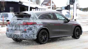 A camouflaged Mercedes-AMG GLC EQ prototype testing in a winter environment
