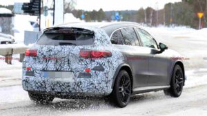 A camouflaged Mercedes-AMG GLC EQ prototype testing in a winter environment