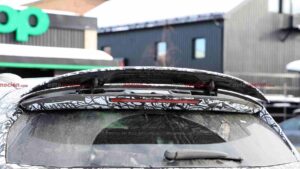 A camouflaged Mercedes-AMG GLC EQ prototype's active rear spoiler