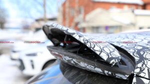 A camouflaged Mercedes-AMG GLC EQ prototype's active rear spoiler