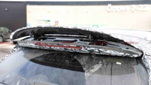 A camouflaged Mercedes-AMG GLC EQ prototype's active rear spoiler