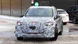 A camouflaged Mercedes-AMG GLC EQ prototype testing in a winter environment