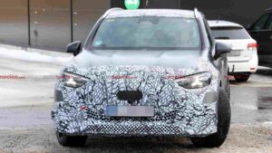 A camouflaged Mercedes-AMG GLC EQ prototype testing in a winter environment