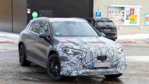 A camouflaged Mercedes-AMG GLC EQ prototype testing in a winter environment