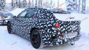 Spy shots of a camouflaged 2027 Mercedes-AMG GT SUV EV in a winter setting