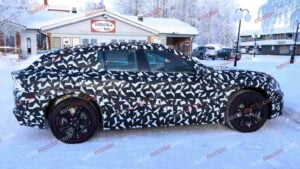 Spy shots of a camouflaged 2027 Mercedes-AMG GT SUV EV in a winter setting