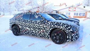 Spy shots of a camouflaged 2027 Mercedes-AMG GT SUV EV in a winter setting