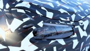 Spy shots of a camouflaged 2027 Mercedes-AMG GT SUV EV's headlight in a winter setting