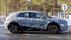 A spy shot of a camouflaged Mercedes-Benz GLA EQ in winter conditiona