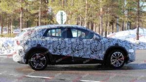 A spy shot of a camouflaged Mercedes-Benz GLA EQ in winter conditiona