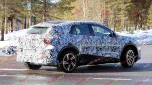 A spy shot of a camouflaged Mercedes-Benz GLA EQ in winter conditiona