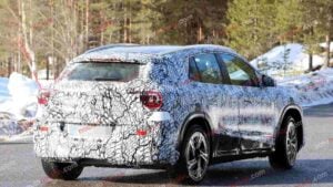 A spy shot of a camouflaged Mercedes-Benz GLA EQ in winter conditiona