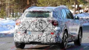 A spy shot of a camouflaged Mercedes-Benz GLA EQ in winter conditiona