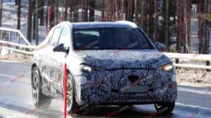 A spy shot of a camouflaged Mercedes-Benz GLA EQ in winter conditiona