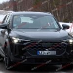 A black Audi Q5 being used as a Porsche Macan mule for winter testing