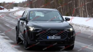 A black Audi Q5 being used as a Porsche Macan mule for winter testing