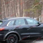 A black Audi Q5 being used as a Porsche Macan mule for winter testing