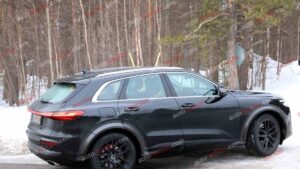A black Audi Q5 being used as a Porsche Macan mule for winter testing