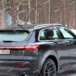 A black Audi Q5 being used as a Porsche Macan mule for winter testing