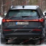 A black Audi Q5 being used as a Porsche Macan mule for winter testing