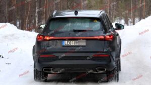 A black Audi Q5 being used as a Porsche Macan mule for winter testing