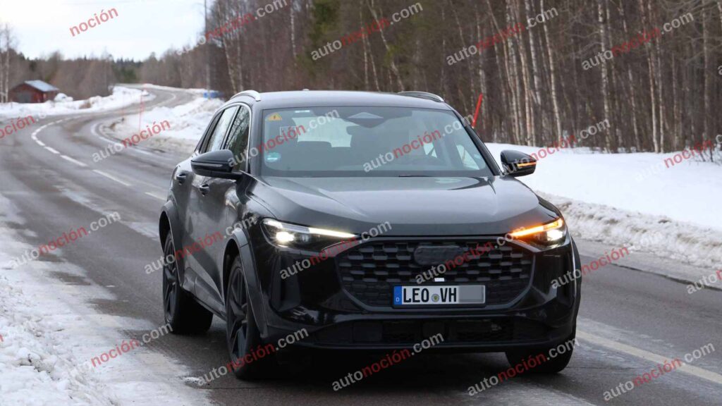 A black Audi Q5 being used as a Porsche Macan mule for winter testing