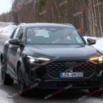 A black Audi Q5 being used as a Porsche Macan mule for winter testing