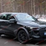 A black Audi Q5 being used as a Porsche Macan mule for winter testing